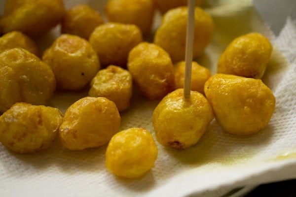 poking holes in fried potatoes.