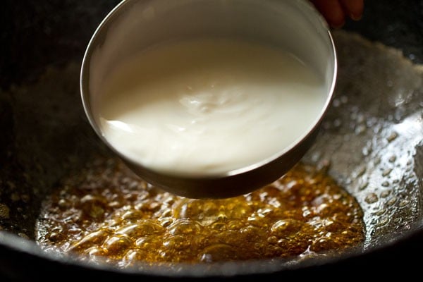 adding beaten curd to the pan.