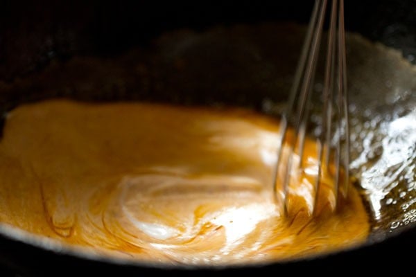 stirring curd into the chili solution.