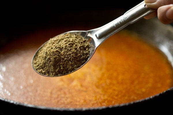 adding fennel powder to pan.