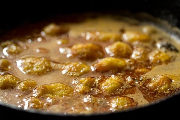fried baby potatoes added to the gravy in the pan.