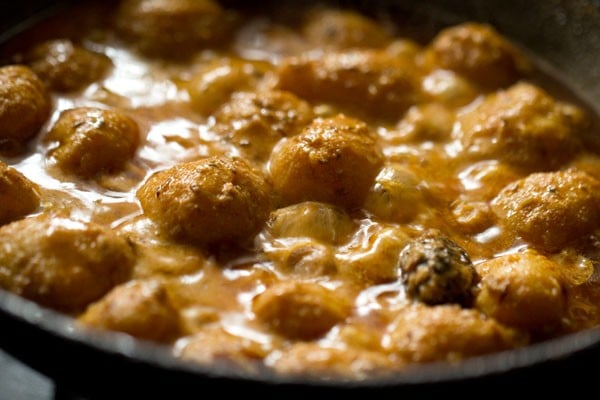 cooking kashmiri dum aloo.