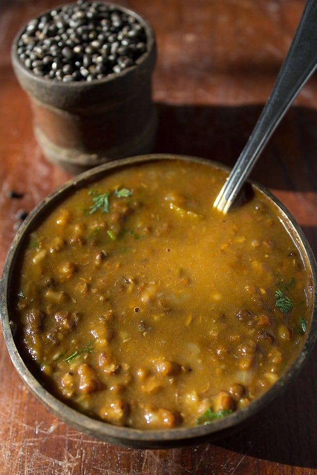 Punjabi maa ki dal served in a bowl with a spoon inside