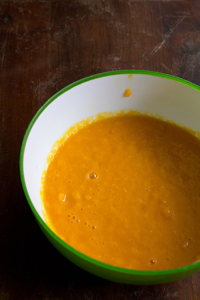 mango puree in a green rimmed white bowl