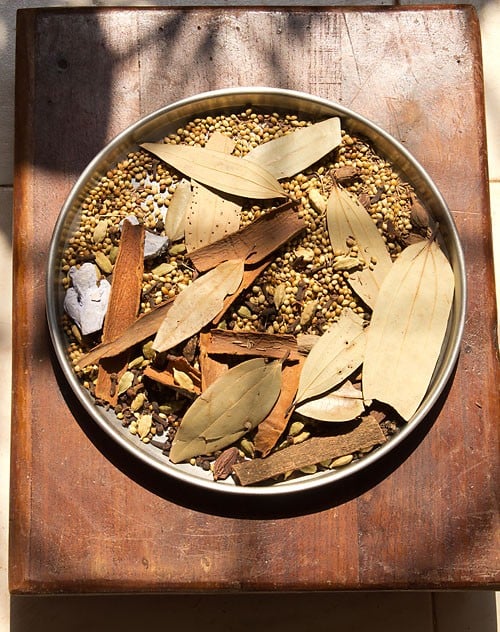 spices on a large plate kept in sunlight for drying.