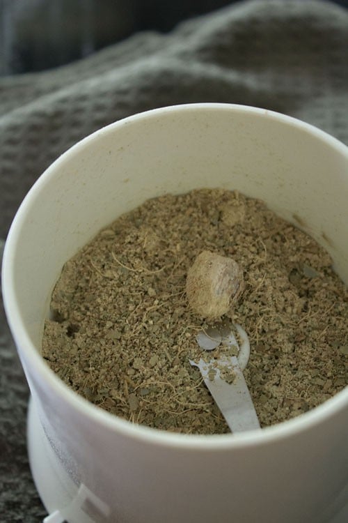 grinding dry ginger root in a spice grinder.