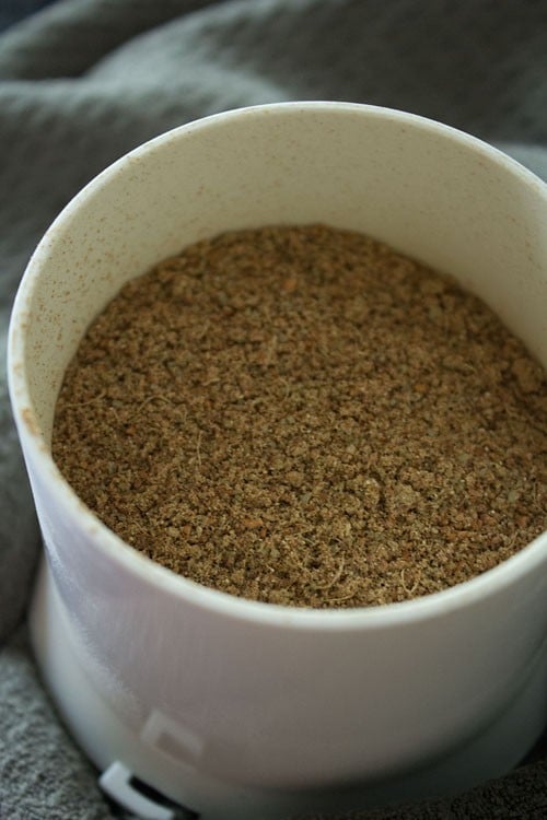 ground spices in spice grinder for making punjabi garam masala.