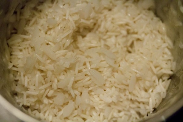 adding rice and poha to wet grinder jar