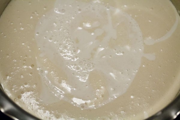 adding rice batter to urad dal batter