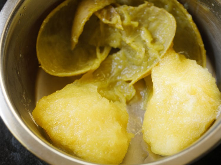 mango pulp is scraped away from the skins for making aam jhora concentrate.