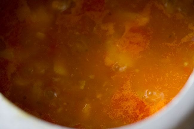 aloo poori curry is beginning to thicken from the potato starch. 