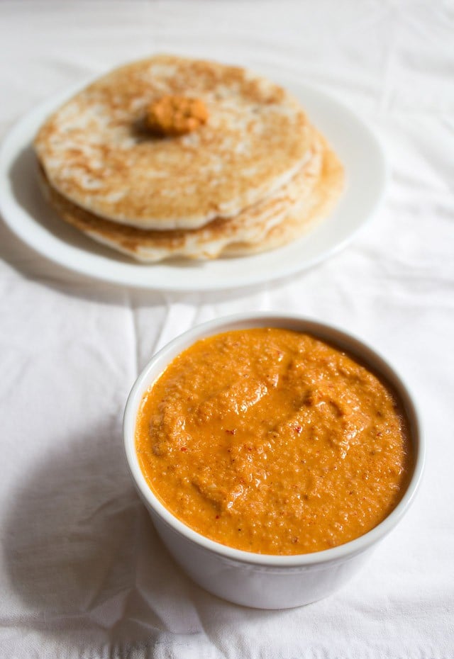 sesame chutney served in a white bowl with dosa