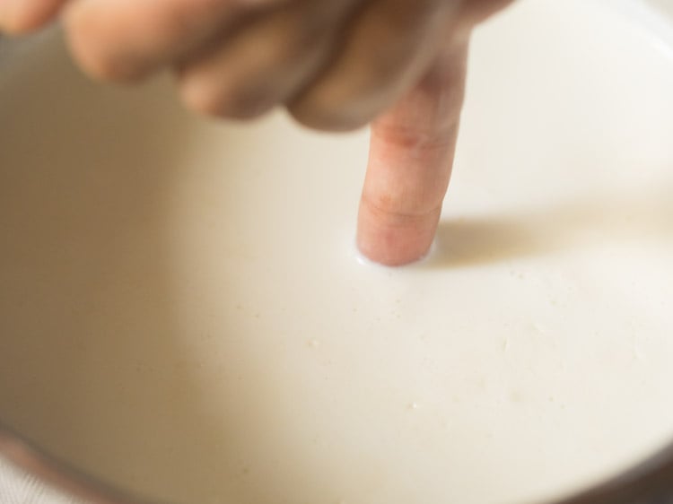 checking milk temperature by using a finger