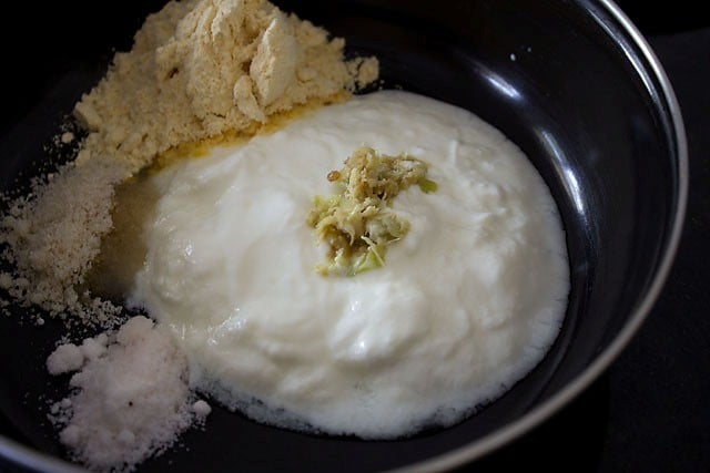 besan curd and sugar in a bowl