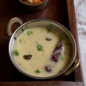 gujarati kadhi garnished with coriander leaves and served with basmati rice and salad.