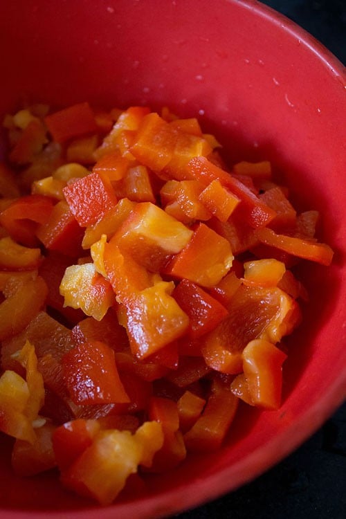 chopped roasted red bell pepper in a bowl for making muhammara dip.