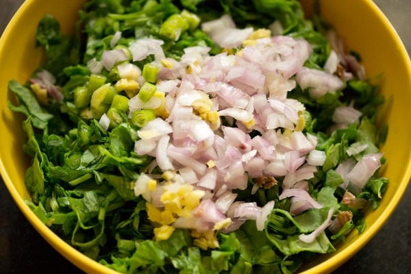 chopped onions, ginger and green chillies added to spinach