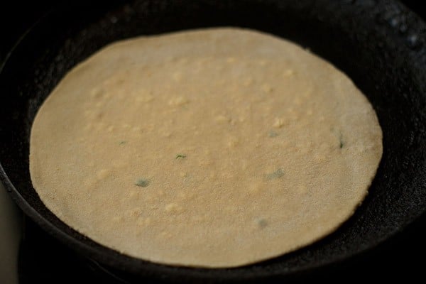 place paneer paratha on a hot griddle