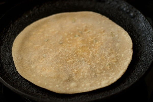 flip paratha when ¼ cooked