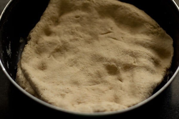 resting dough in a covered bowl