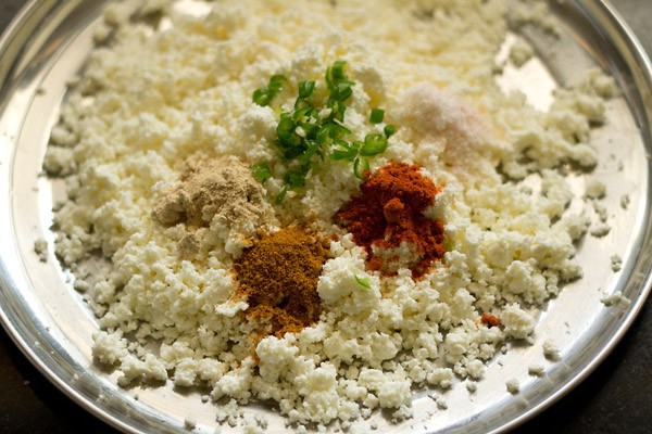 adding spices and green chillies to paneer 