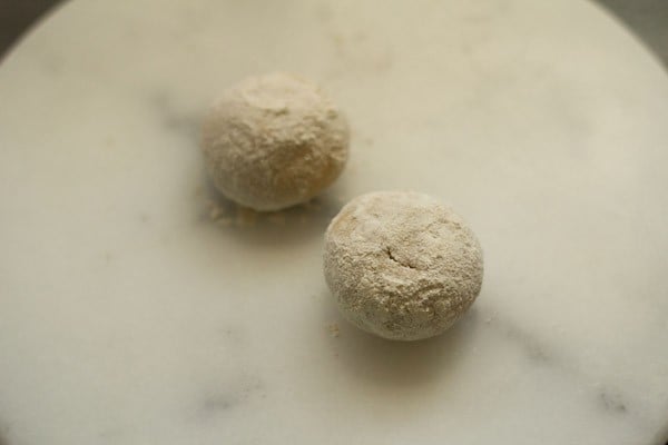 adding flour to dough balls