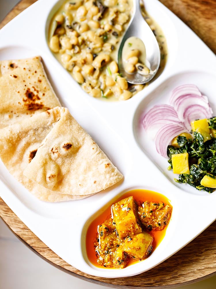 punjabi mango pickle served as a part of an indian meal in a white plate