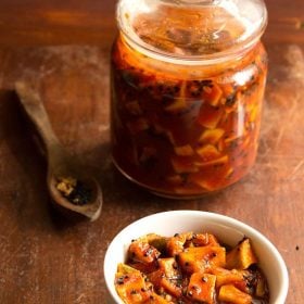 sweet mango pickle served in a bowl and kept in a glass jar