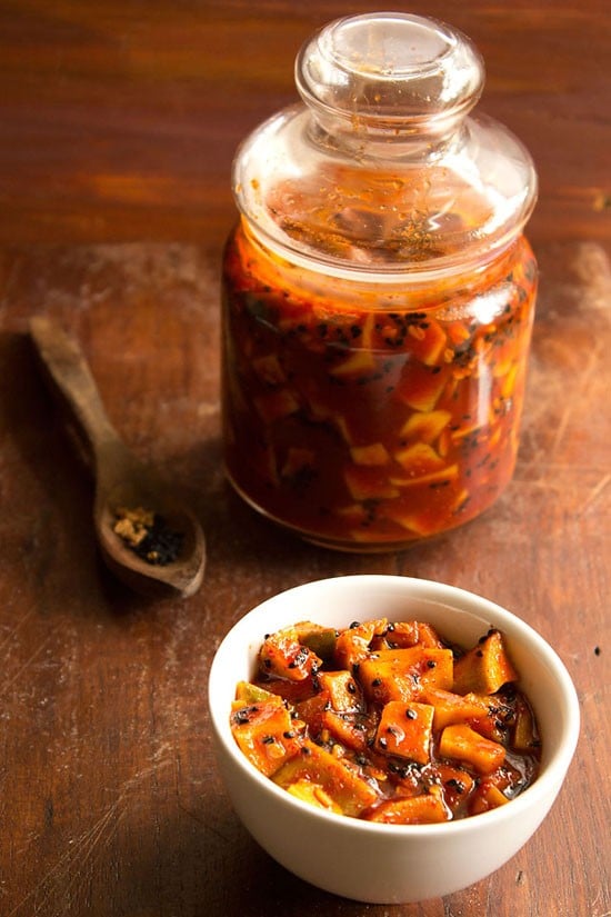 sweet mango pickle served in a bowl and kept in a glass jar