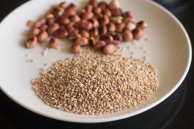 cooling roasted white sesame seeds and peanuts on a plate