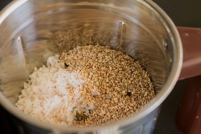 roasted sesame seeds and grated coconut in blender jar