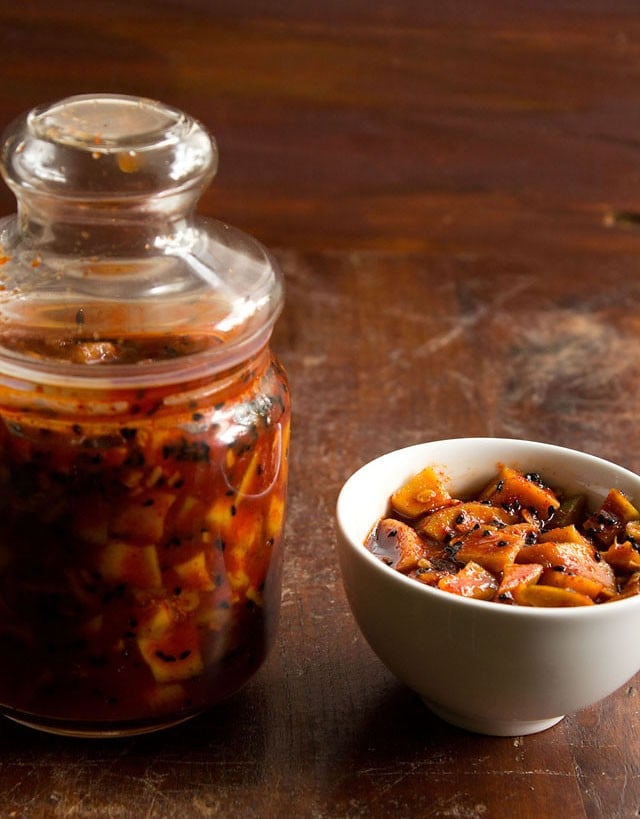  meetha aam ka achar served in a bowl and kept in a glass jar 