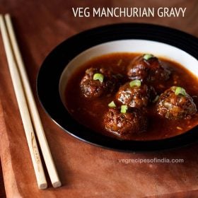 veg manchurian gravy garnished with chopped spring onion greens and served in a black rimmed bowl with chopsticks kept on the left side and text layover.