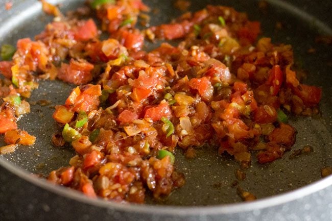 frying tomato masala paste for making sabut  masoor dal. 