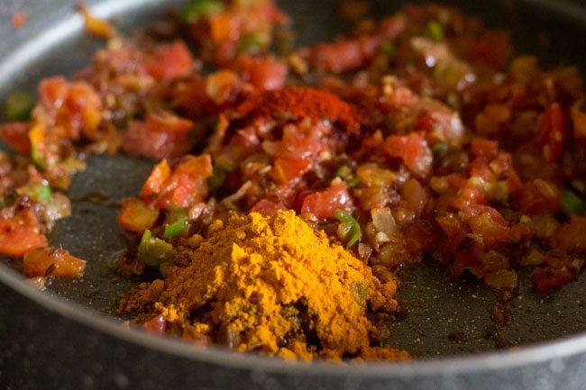 spice powders added to tomato masala paste for making sabut masoor dal. 