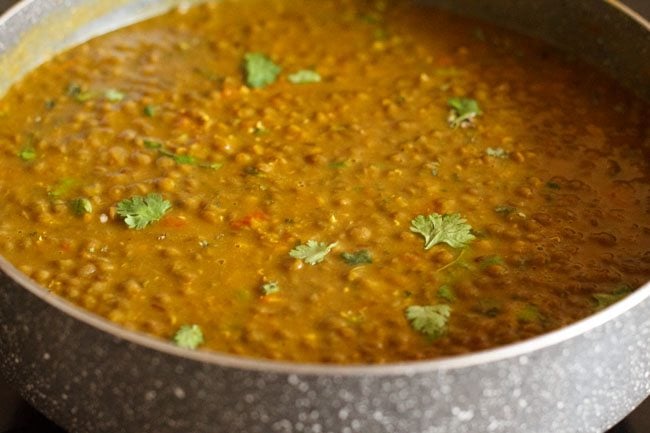 chopped coriander leaves added to cooked lentils. 