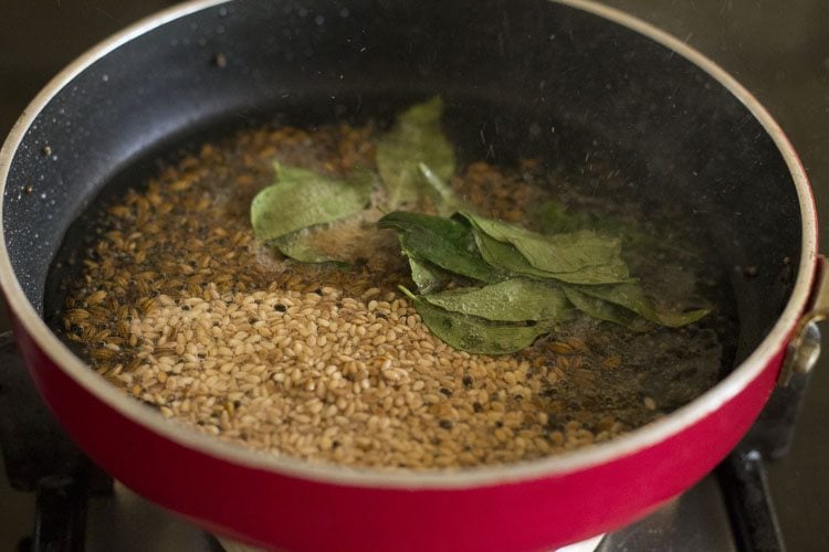 curry leaves, hing, white sesame seeds in oil