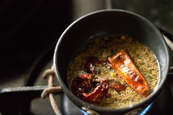 dry red chillies, finely chopped garlic and asafoetida (hing) added in the pan