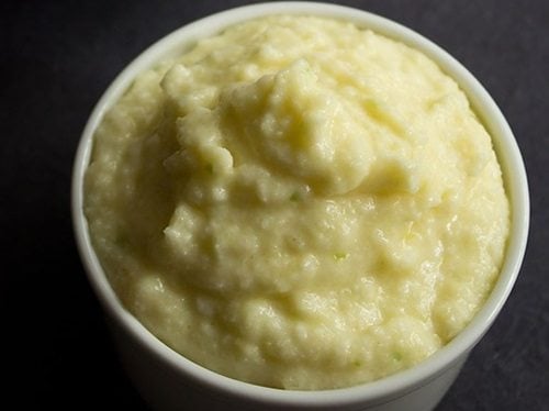 green mango chutney in white bowl.