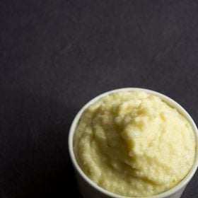 raw mango chutney in white bowl on a black backdrop