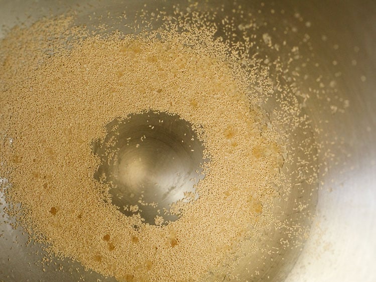added instant yeast and sugar in a stand mixer bowl