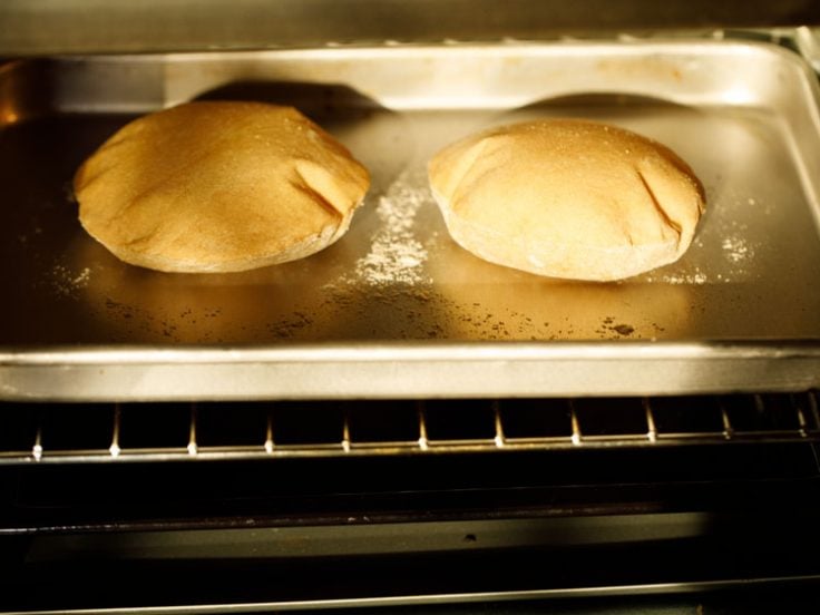 pita breads baking and puffing in the oven