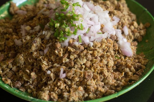 chopped onions and green chili added to black chickpeas coarse mixture