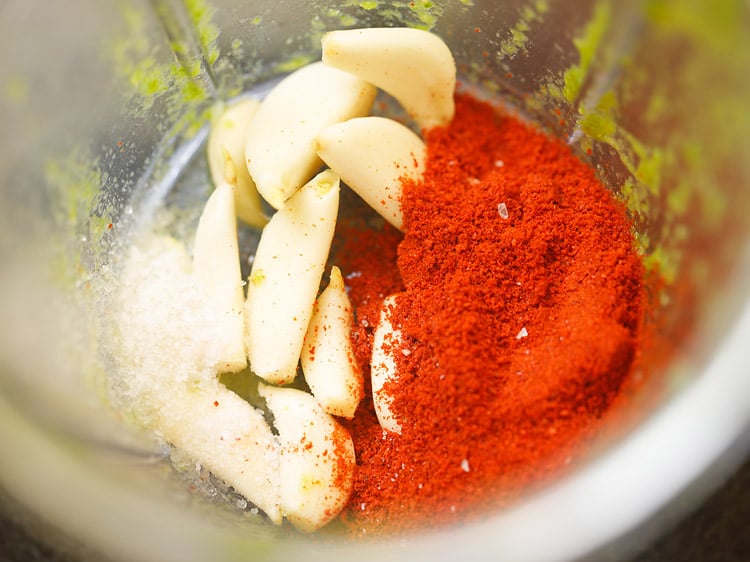 peeled garlic cloves, salt and kashmiri red chilli powder in a blender