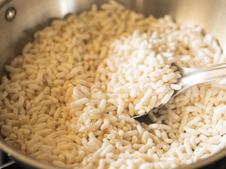 puffed rice being roasted in a kadai 