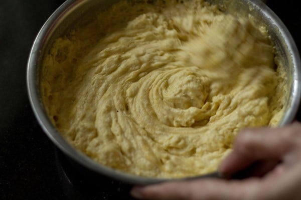 frothy bubbly khaman batter being whisked