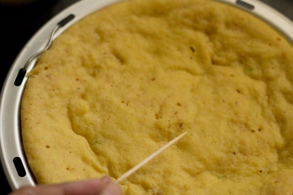 checking khaman with a bamboo toothpick