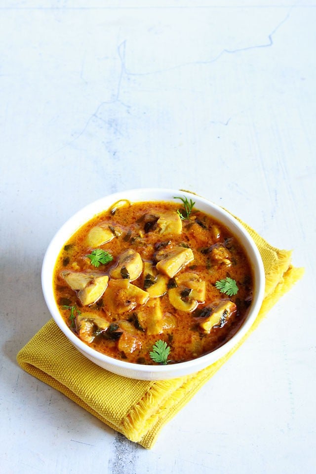 methi mushroom in a white bowl on a yellow napkin.