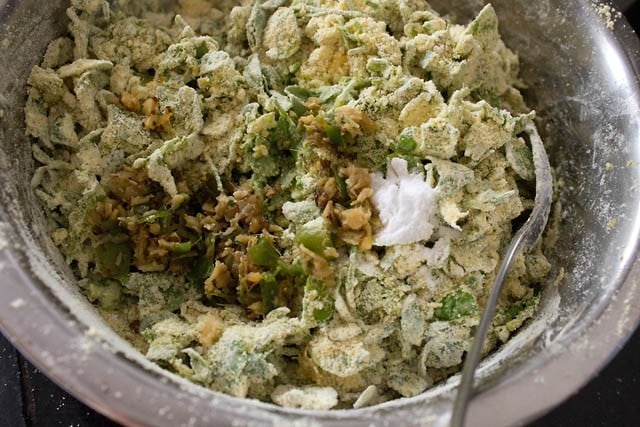 adding ginger-green chili paste, baking soda and lemon juice to muthiya dough ingredients in the bowl