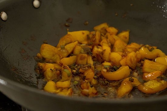 bell peppers are coated in a thin layer of sauce.